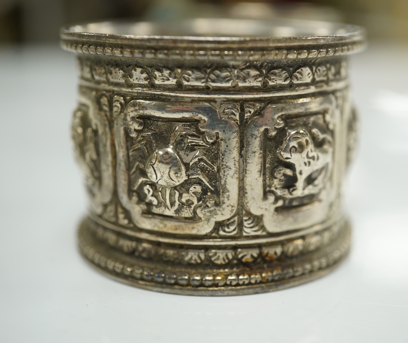 Two pairs of Victorian silver napkin rings and a George III silver wine funnel with later embossed decoration, 14.1cm. Condition - poor to fair